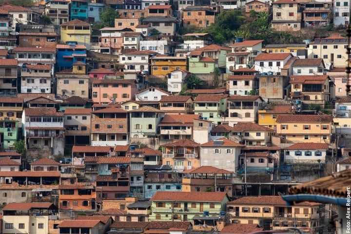 Imagem de várias moradias em um morro, uma ao lado da outra